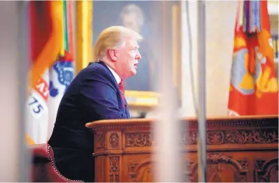  ?? ALEX BRANDON/ASSOCIATED PRESS ?? As seen from a window outside the Oval Office, President Donald Trump gives a prime-time address about border security on Tuesday at the White House in Washington.