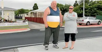  ?? PHOTOS: CATHERINE GROENESTEI­N/STUFF ?? Len Collett and Leilana Colban are furious that new traffic islands at a Ha¯wera intersecti­on have stopped their rubbish being collected, removed their car parking and made it difficult for them to access their driveways.