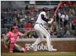  ?? BEN MARGOT — THE ASSOCIATED PRESS ?? The Braves’ Freddie Freeman watches his RBI single off Phillies pitcher Aaron Nola during the first inning Sunday night in Atlanta.