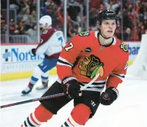  ?? CHRIS SWEDA/CHICAGO TRIBUNE ?? Blackhawks left wing Lukas Reichel turns before celebratin­g his goal with teammates in the first period against the Avalanche on Dec. 19 at the United Center.