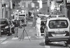  ??  ?? A forensic Officer and a police Officer stand near the scene of the crime in Paris. (Photo: AFP/ Getty Images)