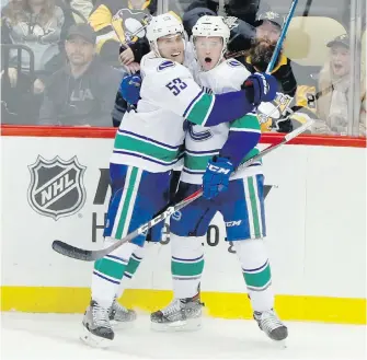  ?? KEITH SRAKOCIC, THE ASSOCIATED PRESS ?? Canucks winger Brock Boeser, right, celebrates with Bo Horvat after scoring the game-winning goal in overtime against the Penguins on Tuesday.