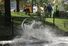  ?? NANCY LANE / HERALD STAFF ?? WATER WORKS: MBTA workers pump out flooded tracks outside the Ruggles station.