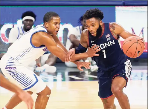  ?? Charles Rex Arbogast / Associated Press ?? UConn’s R.J. Cole (1) drives against DePaul’s Charlie Moore during the first half on Monday in Chicago.