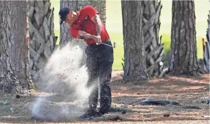  ?? JASEN VINLOVE/USA TODAY SPORTS ?? Tiger Woods plays his shot from the brush during the final round of the Honda Classic.