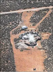  ?? TAOS COUNTY SHERIFF’S OFFICE ?? Eleven hungry children and a youngster’s remains were found in recent days at this filthy compound shielded by old tires, wooden pallets and an earthen wall studded with broken glass.