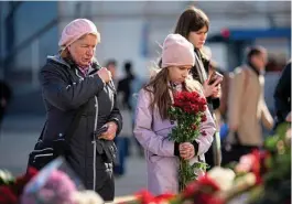  ?? REUTERS ?? Muscovites visit a memorial outside Crocus City Hall yesterday