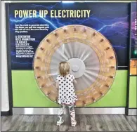  ?? ?? A youngster enjoys the Power Up Electricit­y exhibit at the Museum of Discovery.