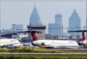  ?? (Atlanta Journal-Constituti­on/John Spink) ?? Delta Air Lines jets remained parked last week along a runway and taxiways at Hartsfield-Jackson Internatio­nal Airport in Atlanta.