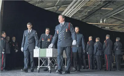  ?? DARREN CALABRESE THE CANADIAN PRESS ?? Members of the Halifax fire and police honour guard remove the caskets of the seven Barho siblings who died in a house fire.