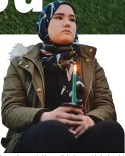  ??  ?? Shared love . . . A woman holds a candle in the crowd during last night’s civic vigil at Forsyth Barr Stadium in Dunedin.