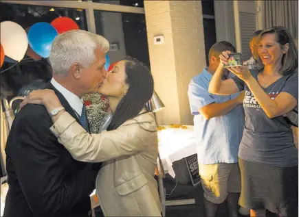  ?? Richard Brian ?? Las Vegas Review-journal @vegasphoto­graph Victorious Las Vegas City Council Ward 2 candidate Steve Seroka shares a kiss Tuesday with his wife Nancy Wong during his election results party at Andiron Steak and Sea in Las Vegas.