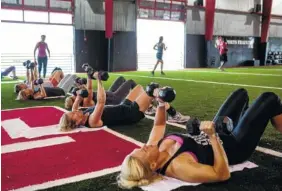  ?? STAFF PHOTO BY DOUG STRICKLAND ?? People train in a group class at D1 Sports Training on Commons Boulevard on Friday in Chattanoog­a.