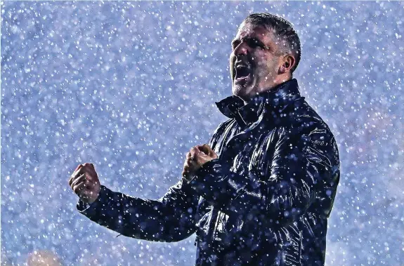  ?? Phil Mingo/PPAUK ?? Plymouth Argyle manager Ryan Lowe, celebrates in front of the the Argyle fans in the pouring rain after the 3-0 win against Bolton Wanderers