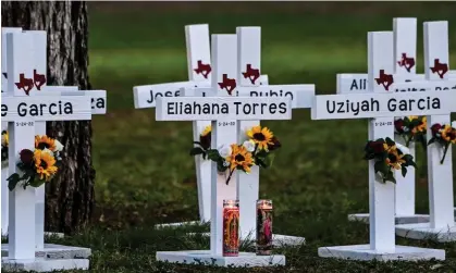  ?? Photograph: Chandan Khanna/ AFP/Getty Images ?? Crosses adorn a makeshift memorial for the shooting victims at Robb elementary school in Uvalde, Texas.