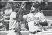  ?? Kathy Willens Associated Press ?? HOWIE KENDRICK, left, and Adrian Gonzalez celebrate after scoring on Justin Turner’s double.