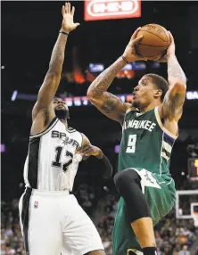  ?? Kin Man Hui / San Antonio Express-News ?? The Bucks’ Michael Beasley, who scored a season-high 28 points, shoots against the Spurs’ Jonathan Simmons.