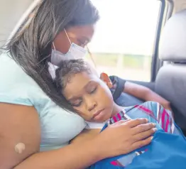  ?? AP ?? Angel Cespedes, 14, is held by his mother Yohelys on their bus ride home after they both got dialysis treatment in Caracas, Venezuela, Monday, Nov 8, 2021. Both Angel and his mother have been on dialysis for years and are in need of kidney transplant­s.