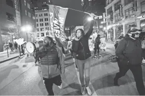  ?? ADAM CAIRNS/COLUMBUS DISPATCH ?? Protestors march Downtown Tuesday following a fatal police shooting earlier in the afternoon on the city’s Southeast Side. A teenage girl was shot and killed as officers responded to an attempted stabbing call.