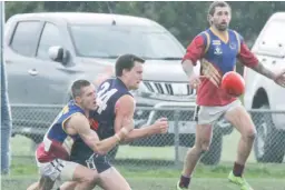  ??  ?? Above: Tyson Bale gets a clearing kick despite a desperate lunging tackle from Catani’s Trent Adams.Right: Catani’s Thomas Van Diemen is brought down in a strong tackle by his Warragul Industrial­s opponent.