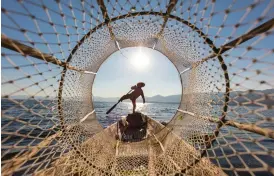  ??  ?? Above FRAMING This fisherman was framed by shooting through his own conical net using a 16-35mm zoom at 16mm. This has produced dramatic perspectiv­e RightGRAPH­IC DESIGN use a long telephoto or telezoom lens to isolate elements in a scene, and utilise perspectiv­e compressio­n to juxtapose them with other elements