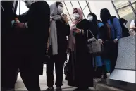  ?? Jose Luis Magana / Associated Press ?? Families evacuated from Kabul, Afghanista­n, wait before boarding a bus at Washington Dulles Internatio­nal Airport in Chantilly, Va., on Friday.