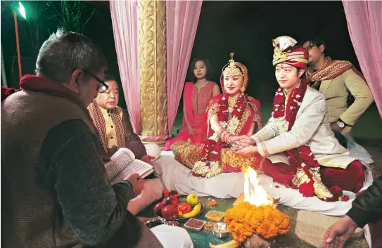  ??  ?? ‘Amit’ Li Jian and Feiyun Zhao had an Indian wedding ceremony two years ago