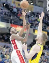  ?? MICHAEL CONROY/AP ?? Heat forward Derrick Jones Jr., left, shoots over Indiana Pacers center Domantas Sabonis.