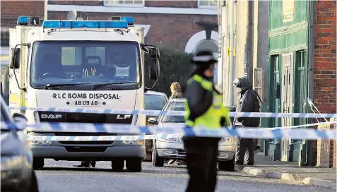  ??  ?? Police and a bomb disposal team at the scene of one of the raids, above, in Chesterfie­ld yesterday. Sheffield’s Fatima Community Centre, top right, was also searched