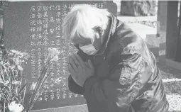  ?? YUICHI YAMAZAKI/GETTY ?? Takao Fujisaki prays Thursday in Namie, Japan, on the 10th anniversar­y of an earthquake that spawned a tsunami. Fujisaki lost his daughter and grandson.