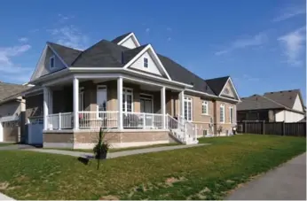  ?? COLDWELL BANKER R.M.R. REAL ESTATE PHOTOS ?? The all-brick exterior of the home includes modern windows and a double entry door with glass inserts.