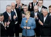  ?? MATTHIAS SCHRADER/AP ?? Party board members applaud German Chancellor Angela Merkel’s success after national elections Sunday in Berlin.