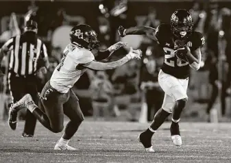  ?? David Purdy / Getty Images ?? Baylor safety Christian Morgan, left, can’t catch Iowa State running back Breece Hall during the Bears’ loss Nov. 7. After winning its first game of the season, Baylor has dropped four straight.