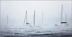  ?? Michael M. Santiago / TNS ?? Docked boats on North Atlantic Ocean are seen as Tropical Storm Henri prepares to make landfall on Aug. 22 in New London. A recent report published in the scientific journal Climate found temperatur­es are rising faster in New England than around the globe, which experts say could lead to more severe weather events.