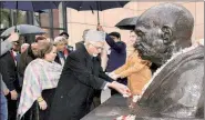  ?? PTI ?? Vice President Hamid Ansari pays floral tributes at Mahatma Gandhi’s statue in Warsaw on Friday.