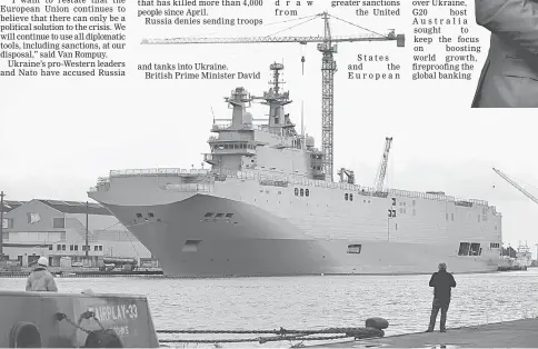  ?? — AFP photo ?? Tony Abbott A photo taken in Saint-Nazaire, western France, shows the Vladivosto­k warship, a Mistral class LHD amphibious vessel ordered by Russia to the STX France shipyard. The Vladivosto­k warship is one of two navy ships ordered to France by the...