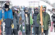  ??  ?? Skiers wait to be called into The Gondola corral per pandemic protocols at Winter Park on Feb. 13.