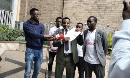  ?? ?? Reuben Kigame, centre, in Nairobi, after Kenya’s Electoral Commission disqualifi­ed him from running in the presidenti­al election. Photograph: @chebet_birir