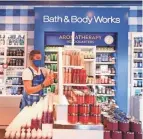  ?? TIM JOHNSON/COLUMBUS MONTHLY ?? Assistant manager Zachary Devine works on displays at the Bath & Body Works location at Easton.