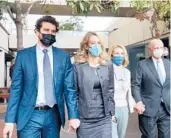  ?? JIM WILSON/THE NEW YORK TIMES ?? Elizabeth Holmes, second from left, the founder of the blood testing start-up Theranos, outside court on Jan. 3 during her fraud trial in San Jose, California. She was later found guilty on four counts of fraud.