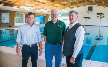  ?? WILLIAM HARVEY/RIVER VALLEY & OZARK EDITION ?? From left, TR Santos, director of aquatics for the city of Russellvil­le; Mack Hollis, director of Russellvil­le Recreation & Parks; and Mayor Randy Horton stand inside the city’s new $6.6 million aquatic center. The facility is scheduled to open in...