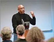  ?? TIM MARTIN/THE DAY ?? Author Charles Fort of New Britain, a retired professor at Southern Connecticu­t State University, reads excerpts from several of his books as members of the Writers Resist of Southeast Connecticu­t and local writers gather in the Community Room of the...