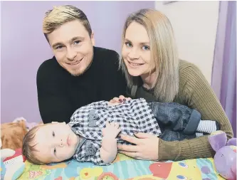  ??  ?? Archie Benton with his dad Adam and mum Katie Craggs.