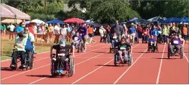  ?? PHOTO BY ESTHER AVILA ?? Wheelchair­s race toward the finish line Friday during the 2017 Tulare County Special Olympics held at Bob Mathias Stadium in Tulare. Numerous Portervill­e-area residents participat­ed in the event which had 850 athletes.