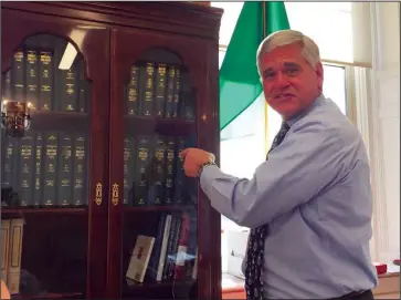  ?? Jonathan Bissonnett­e photo ?? Attorney General Peter F. Kilmartin shows off his legal library in his Providence office. Twice elected to the office of Rhode Island’s “Top Cop,” Kilmartin is leaving his post after serving the state limit of two, four-year terms.