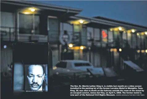  ?? ANDREA MORALES/THE NEW YORK TIMES ?? The Rev. Dr. Martin Luther King Jr. is visible last month on a video screen installed in the parking lot of the former Lorraine Motel in Memphis, Tenn. King, 39, was shot to death on the balcony outside his room at the motel by an escaped convict,...