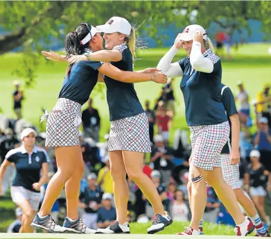  ?? Picture: AFP ?? GREAT DAY AT THE OFFICE: Danielle Kang and Austin Ernst of Team USA celebrate after the final day singles matches of The Solheim Cup at Des Moines Golf and Country Club in West Des Moines, Iowa, on Sunday