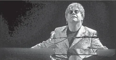  ?? JIM WEBER/THE COMMERCIAL APPEAL ?? April 14, 2001: Pop music icon Elton John finishes the final chords of his first duet with fellow superstar Billy Joel at The Pyramid.