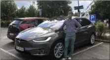  ?? LENE MARIE BRYNILDSEN — COURTESY OF NILS HENNINGSTA­D VIA AP ?? In this photo provided by Nils Henningsta­d, Henningsta­d poses next to his Tesla Model X while charging the electric car at a public charging station, Thursday in Lillestrom, just outside Oslo, Norway. Electric cars are seeing growing support around the...