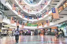  ??  ?? Moody’s Investors Service expects Malaysia to achieve its target of reducing the fiscal deficit to 2.8 per cent of Malaysia’s GDP in 2018 from three per cent this year, given the supportive economic growth and commodity price environmen­t. — AFP photo
